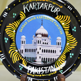 Decorative plate with a depiction of Darbar Sahib Kartarpur Pakistan and 'Kartarpur' text.