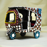 Decorative model of a Rikshaw with mosaic art on a neutral background
