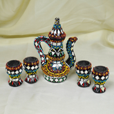 Decorative ceramic set with a kettle and four cups on a beige background