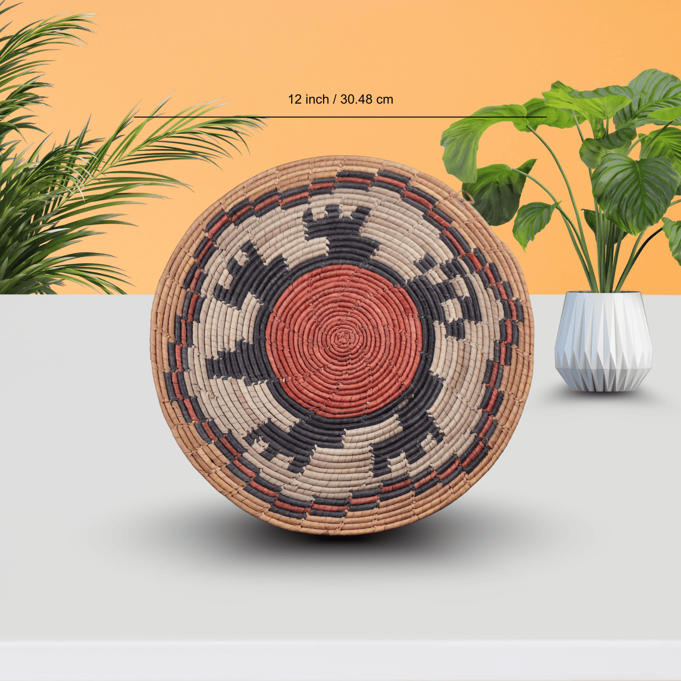 Circular vintage handwoven placemat with a geometric pattern in earthy red and black tones, handcrafted by Pakistani artisans.