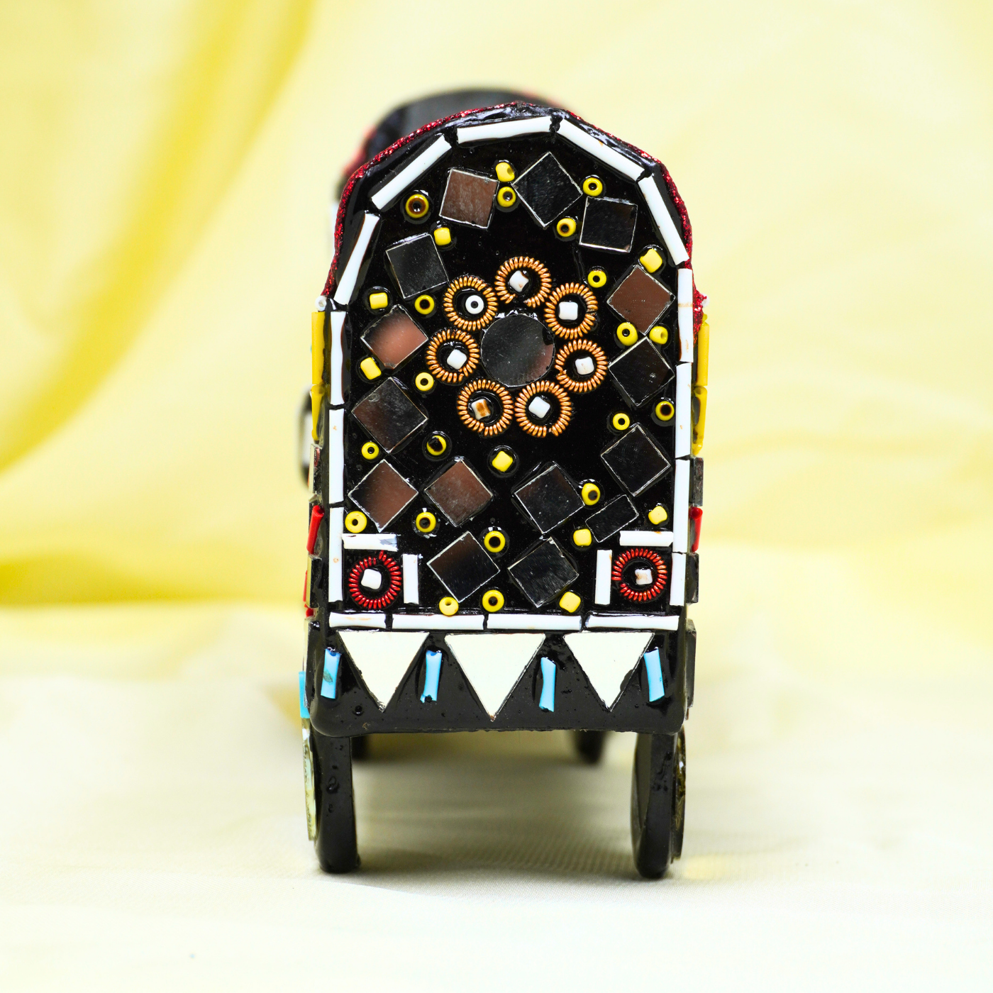 Decorative toy truck with colorful patterns on a light background