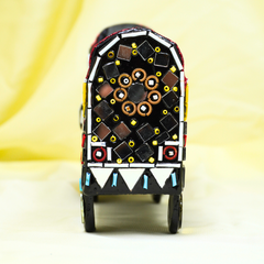 Decorative toy truck with colorful patterns on a light background