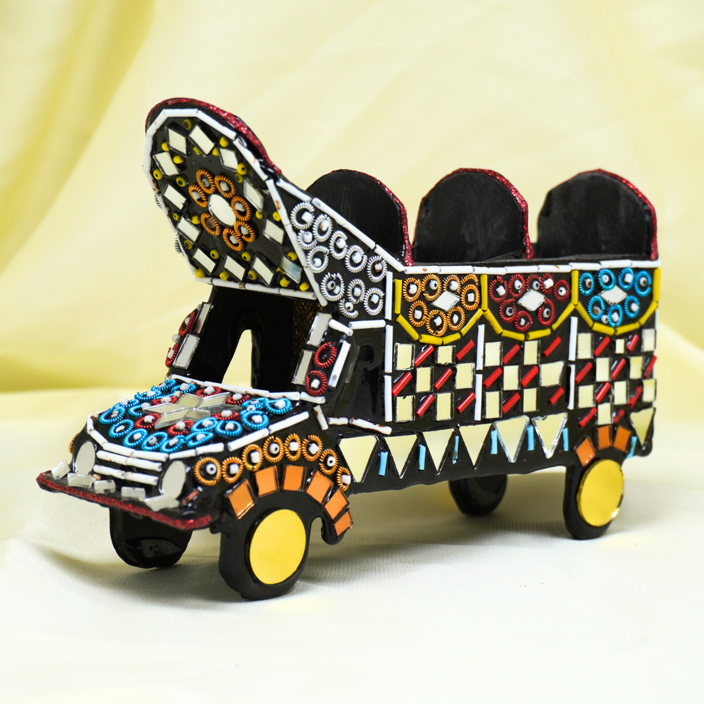 Decorative toy truck with colorful patterns on a light background