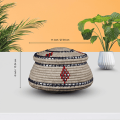 Decorative woven basket with measurements on a light gray background with plants.