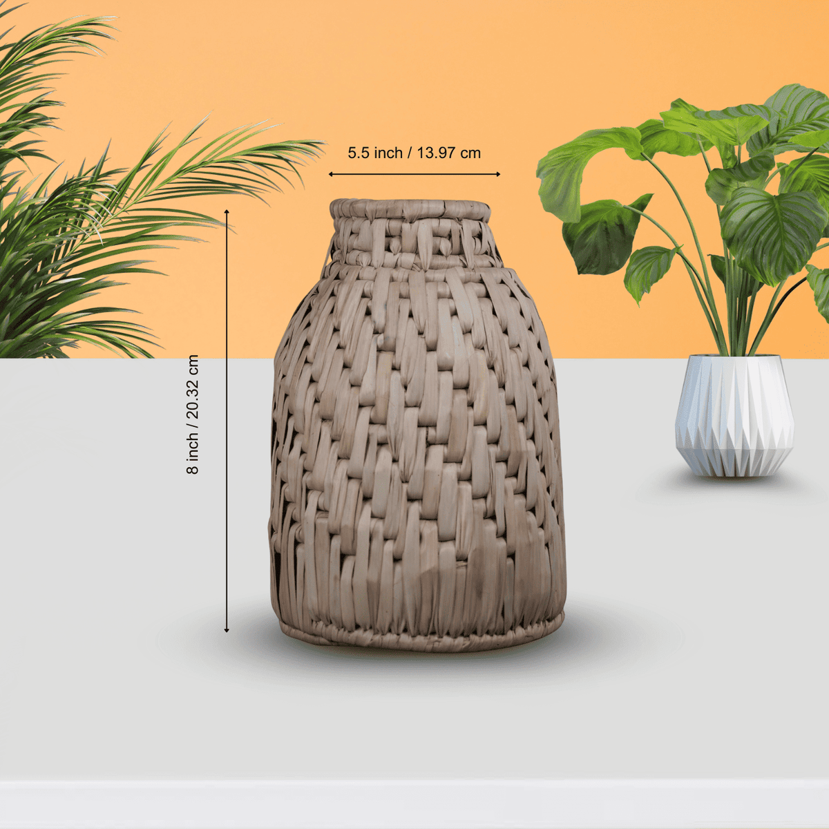 Woven vase with dimensions indicated, set against a neutral background with plants.