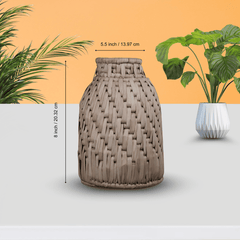 Woven vase with dimensions indicated, set against a neutral background with plants.